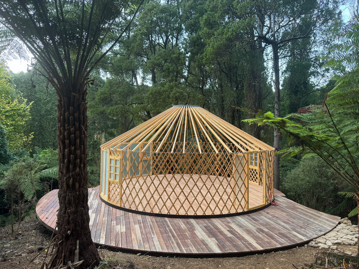 Wooden yurt in a forest setting