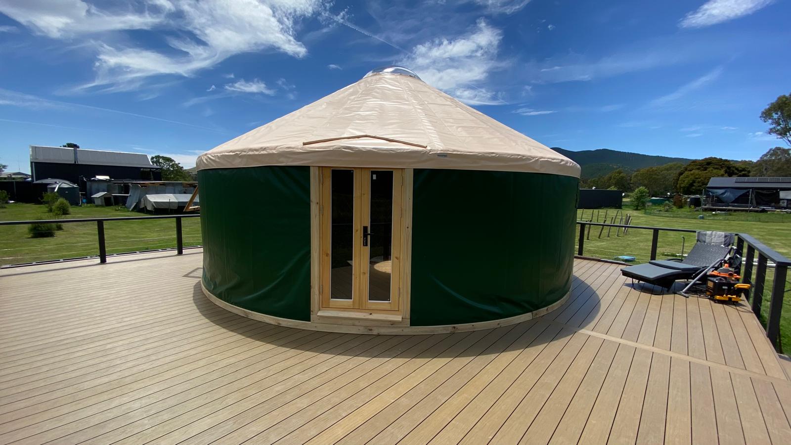 7 metre yurt on a wooden deck with a clear blue sky