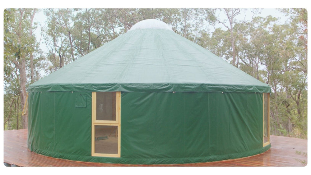 Green yurt exterior with a Floor-to-Ceiling Window bringing light into the circular space.