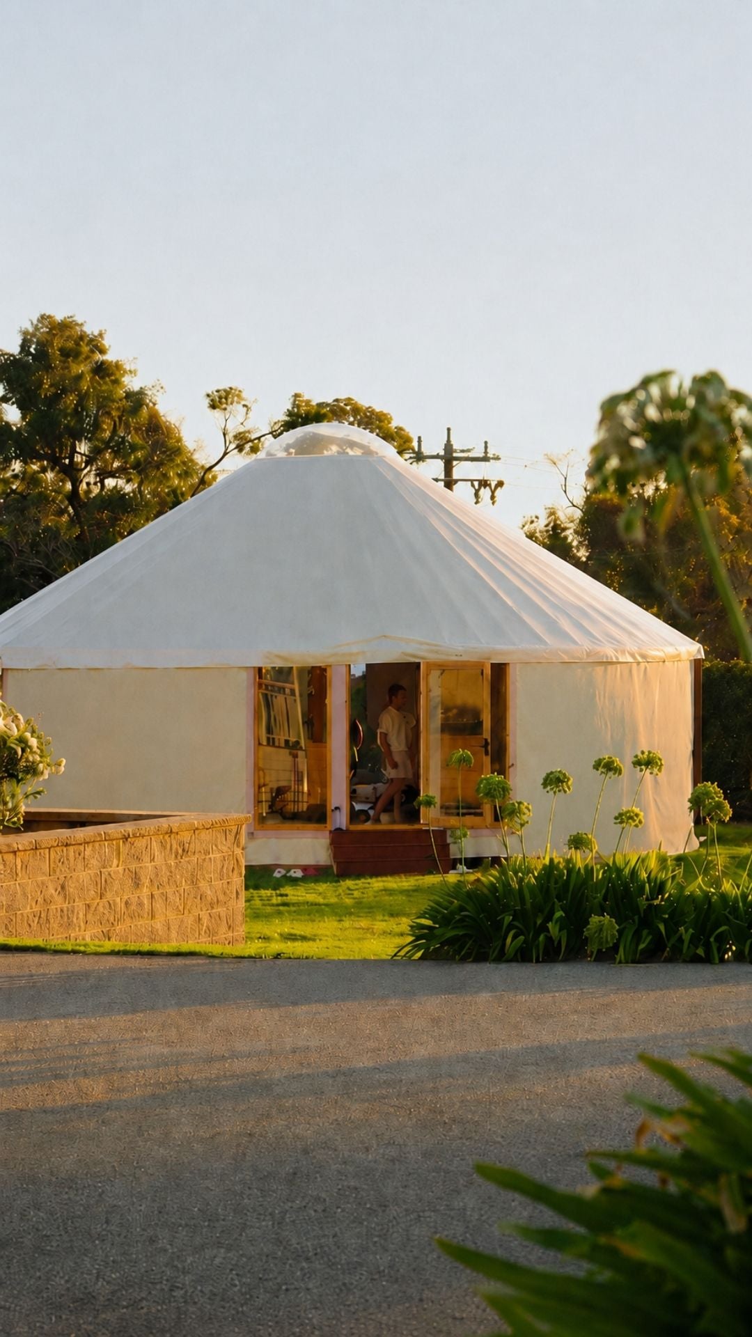 Exterior view of a modern yurt in a natural landscape