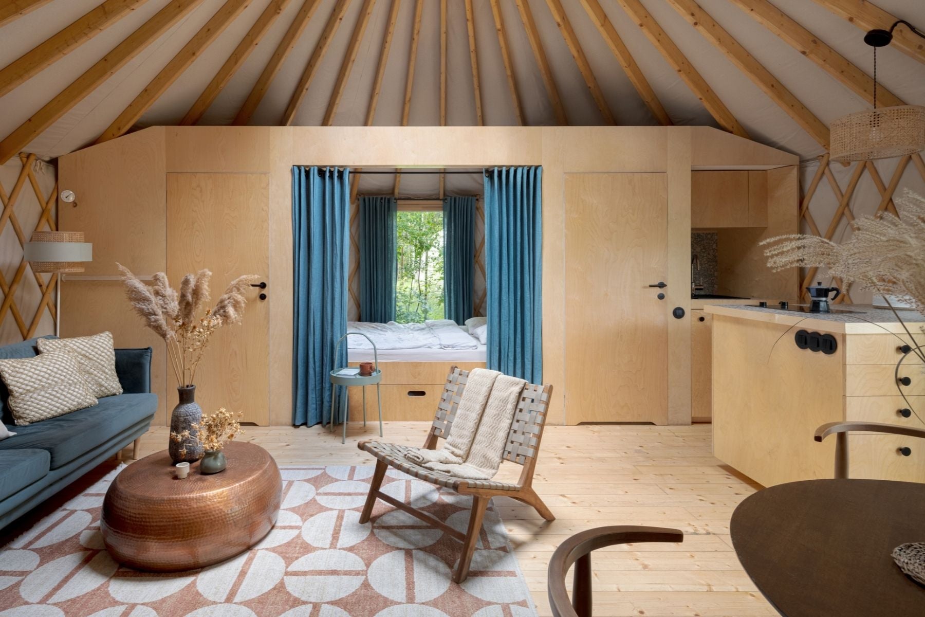 Styled yurt interior with furniture, lounge seating and soft lighting designed for comfortable everyday living