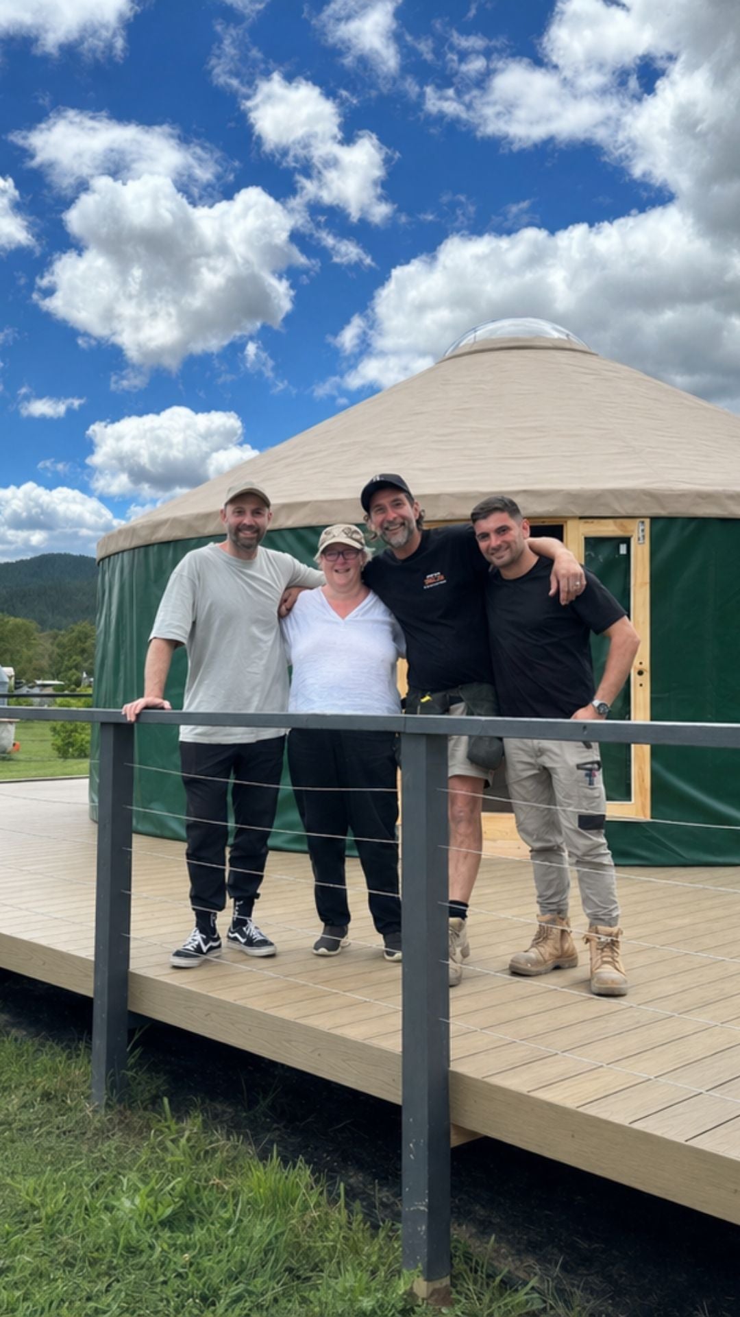 Yurt connected to a deck beside a home with people standing outside, showing seamless extension of space