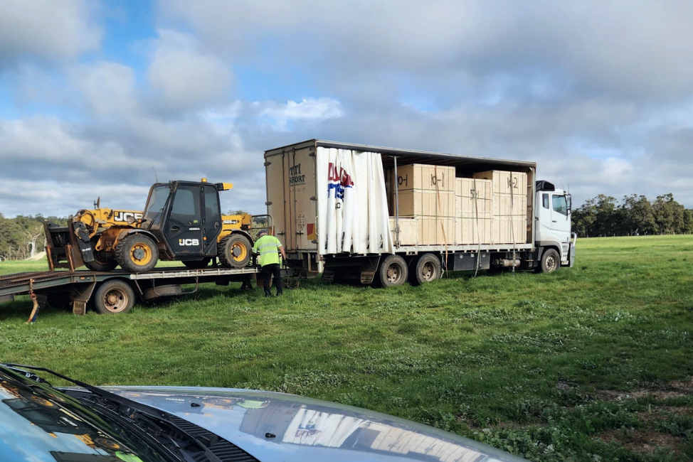 Beyond Yurt modular kit crates arriving on a delivery truck, ready to be unloaded on site.