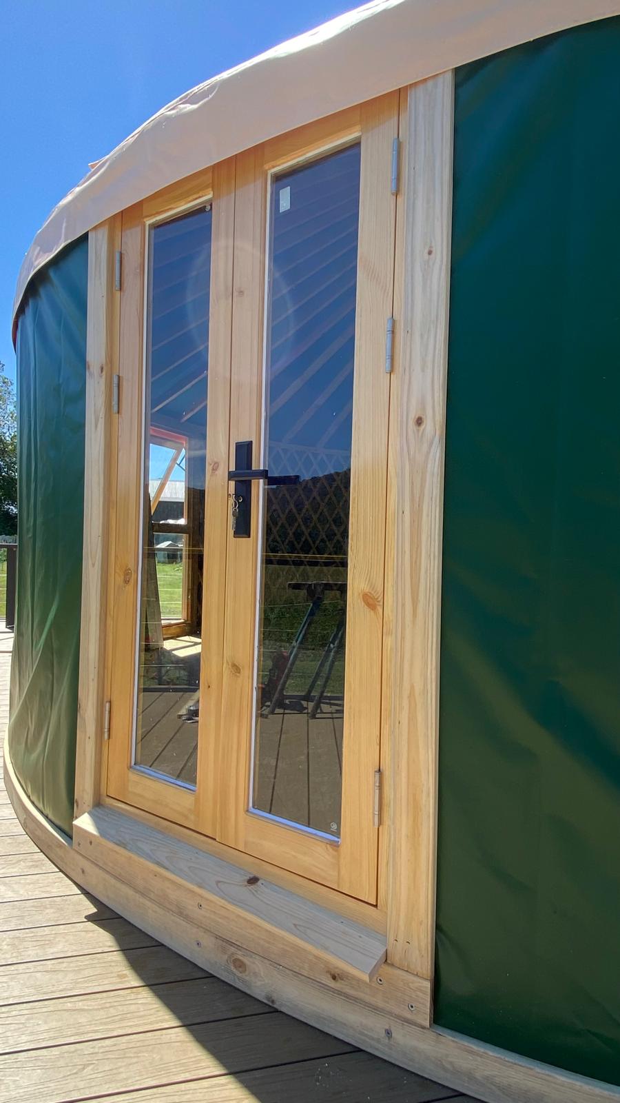 Yurt double doors with wooden trim around the edges
