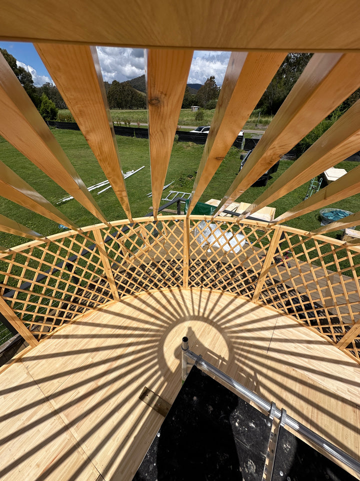 Yurt frame creating shadows on a sunny day