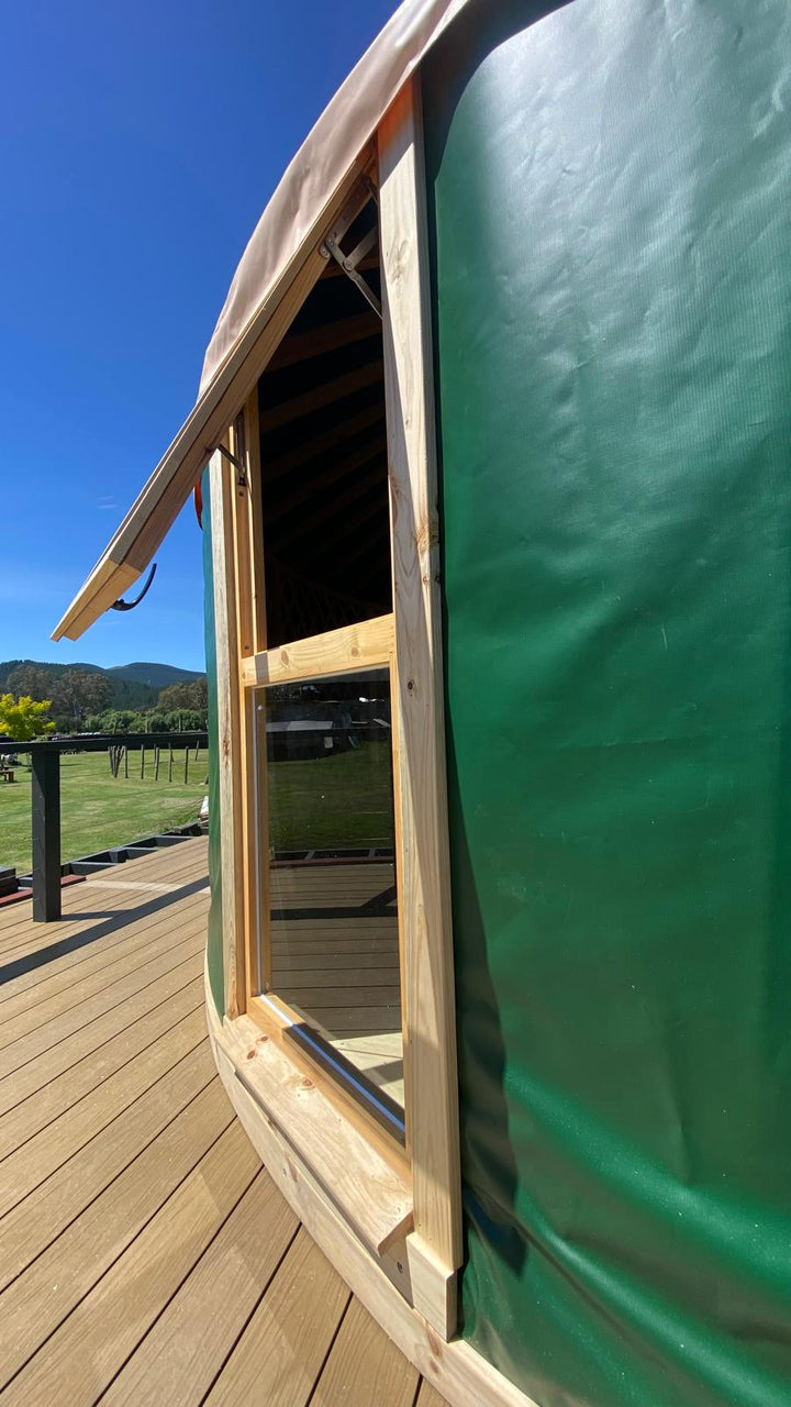 Yurt open window with wooden trim around the edges