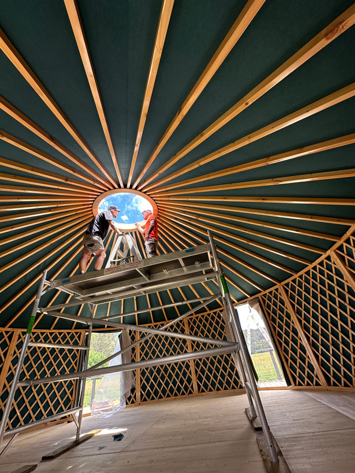 Scaffolding inside wooden yurt during installation